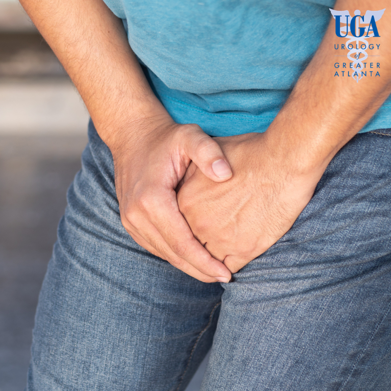 A man suffering from Testicular Contusion holding his groin area while experiencing severe pain in Atlanta, Georgia.