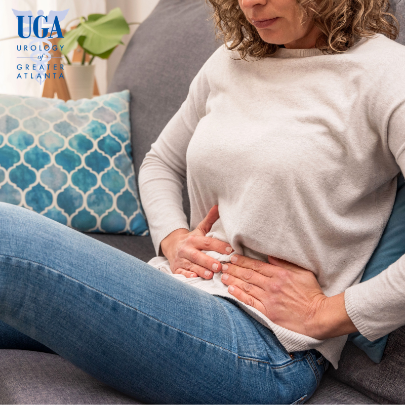A woman experiencing lower abdominal pain caused by bladder trauma in Atlanta, Georgia.