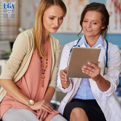 A urologist in Atlanta reviewing urinary urgency symptoms of her patient.